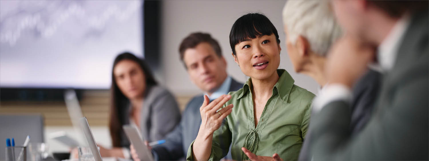 Asian businesswoman talking to her colleagues in the office
